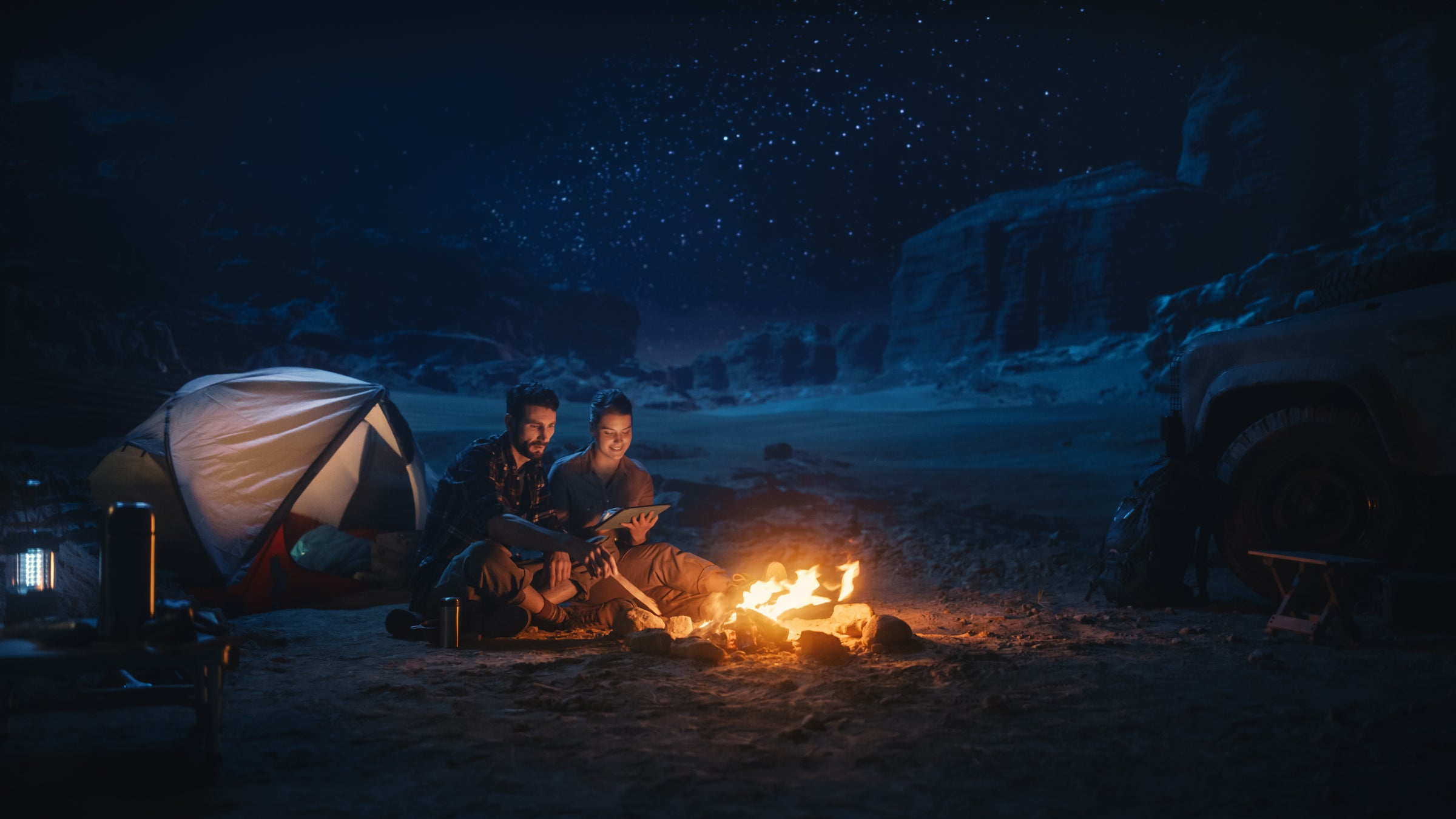couple camping using device